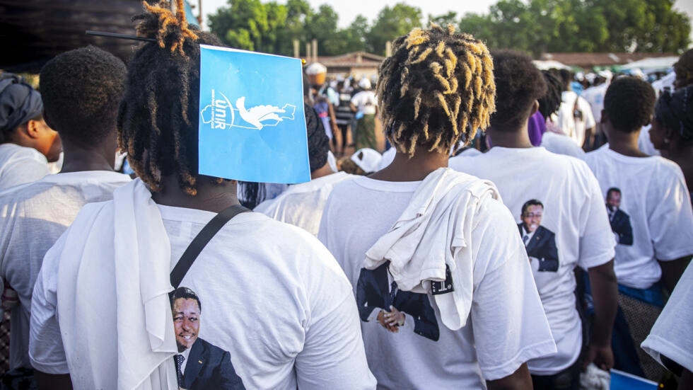 Supporters of the Union for the Republic (UNIR) wear t-shirts with the portrait of Togolese President Faure Gnassingbe on it during a campaign meeting in Lome on April 27, 2024. © Dodo Adgoli, AFP