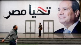 File photo: A man walks in front of a billboard for Egyptian President Abdel-Fattah al-Sisi reading "Long live Egypt", Cairo, Egypt, January 27, 2022. © Amr Nabil, AP archive