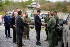 President Biden talking with U.S. Border Patrol officers along the Rio Grande on Thursday. PHOTO: EVAN VUCCI/ASSOCIATED PRESS