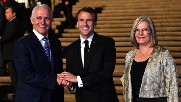 GETTY IMAGES / Mr Macron, centre, with Mr and Mrs Turnbull at the Sydney Opera House on Tuesday evening