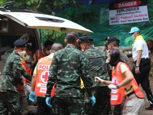 Thai soldiers and paramedics assist a rescued boy on a stretcher to an ambulance near the cave. Picture: AFP Photo / CHIANG RAI PUBLIC RELATIONS OFFICESource:AFP