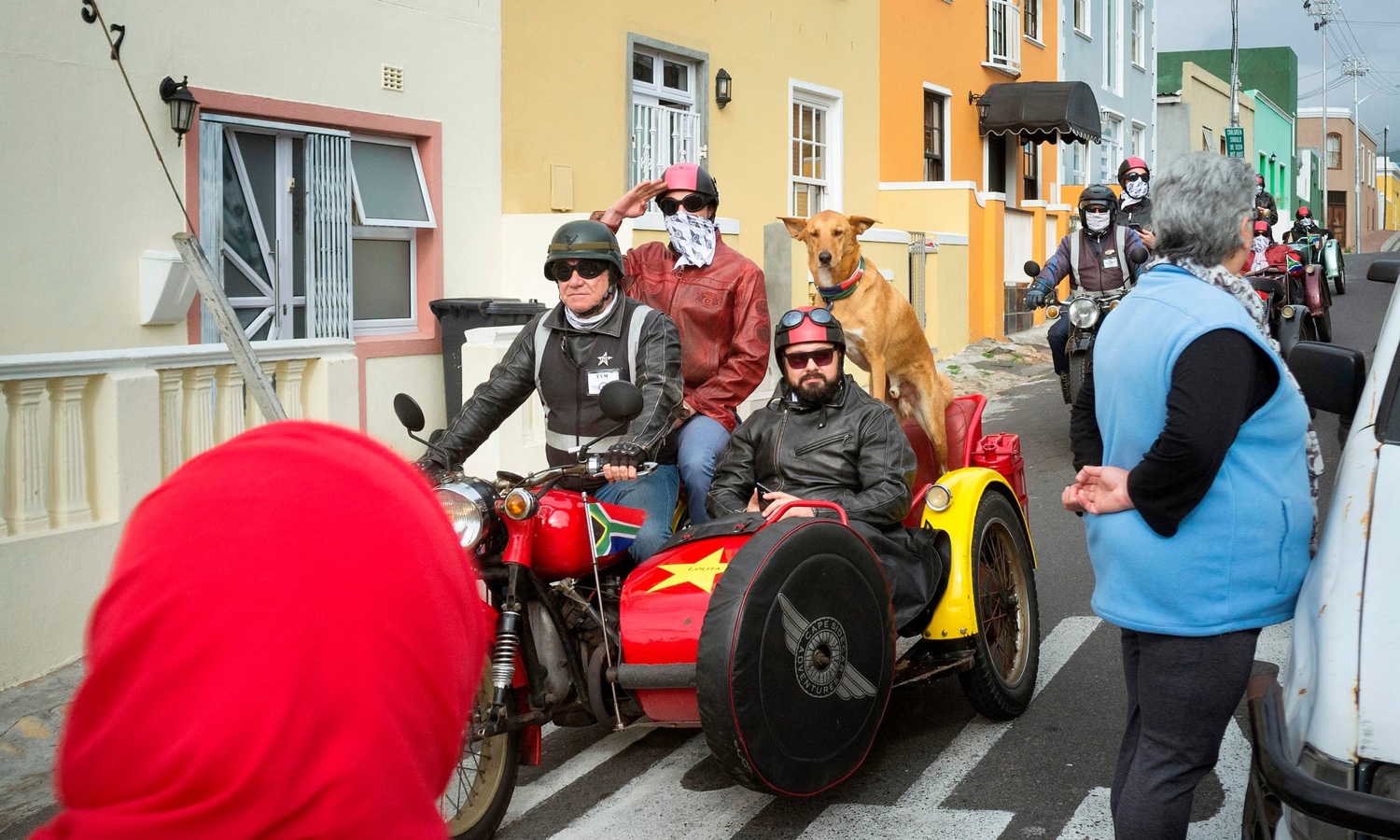   Tourists ride through Bo-Kaap on motorcycles. The district is a big draw for visitors. Photograph: Rodger Bosch/AFP/Getty Images