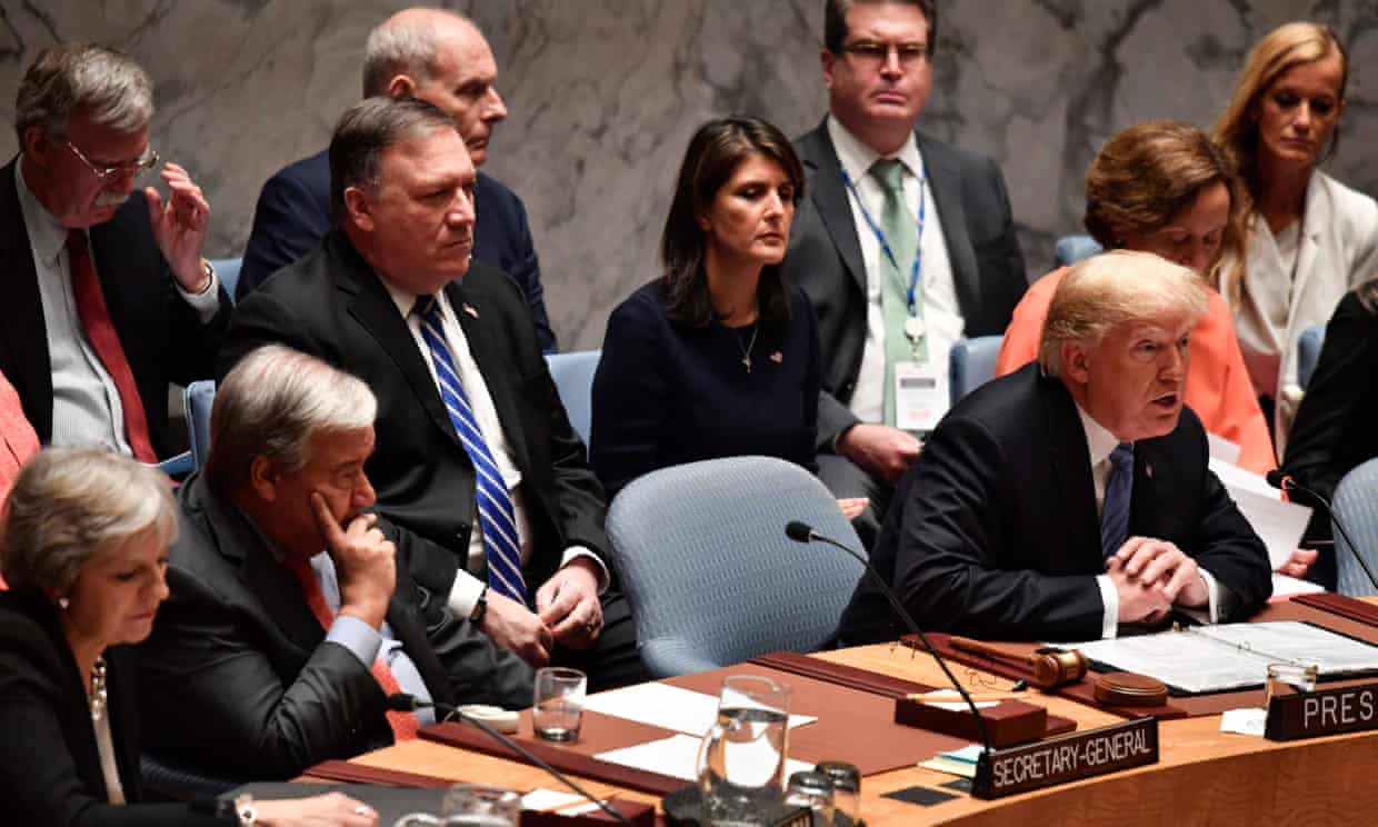 Donald Trump chairs a session of the UN security council flanked by the secretary general, António Guterres and the British prime minister, Theresa May, and backed by US officials. Photograph: Nicholas Kamm/AFP/Getty Images