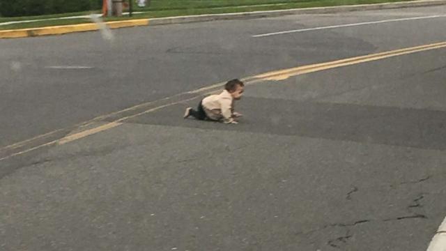 Father charged with neglect after photo of baby crawling in street goes viral (ABC News)