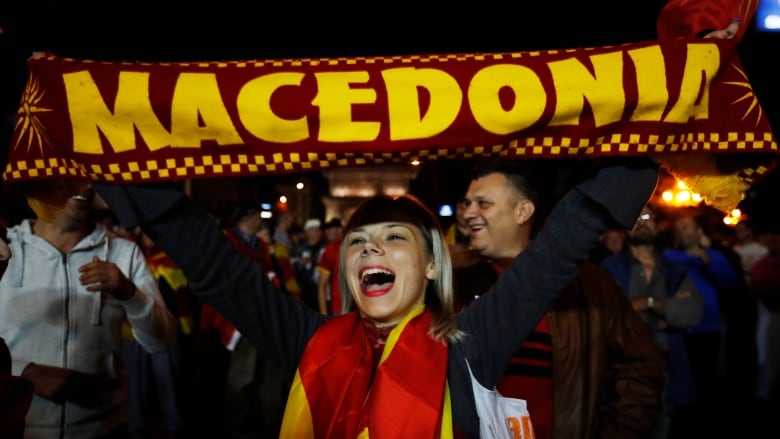 A supporter of a movement for voters to boycott the referendum celebrates in central Skopje, Macedonia, after election officials gave low turnout figures on Sunday. (Thanassis Stavrakis/Associated Press)