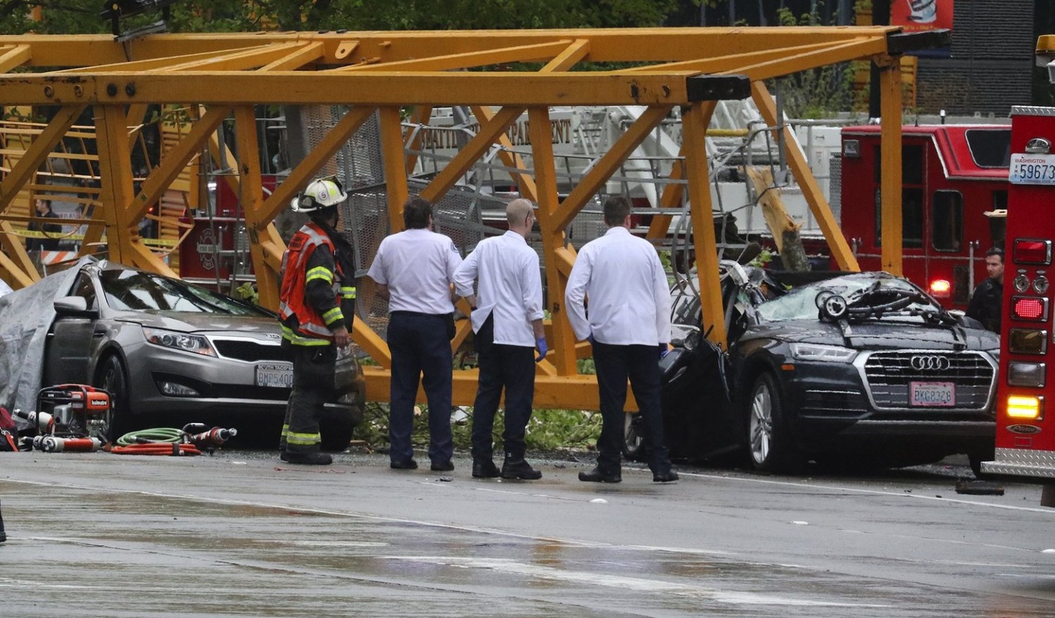 Emergency crews investigate the scene of a collapsed crane at Fairview Avenue North and Mercer Street in Seattle’s South Lake Union neighborhood Saturday afternoon. (Alan Berner / The Seattle Times)