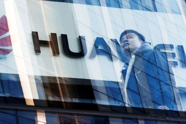 A man walks past a Huawei shop in Beijing, China, March 7, 2019. Thomas Peter | Reuters