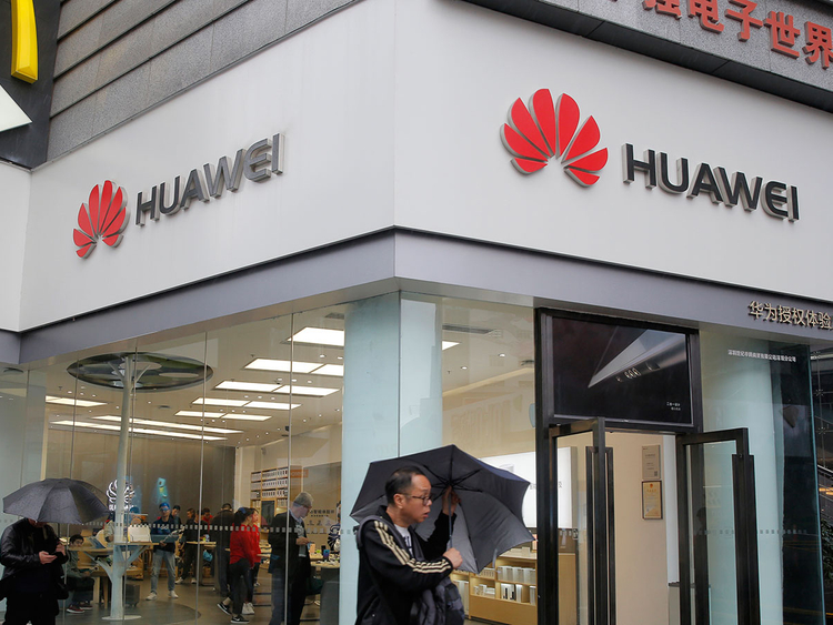 A man walks past a Huawei retail shop in Shenzhen, China's Guangdong province. Image Credit: AP