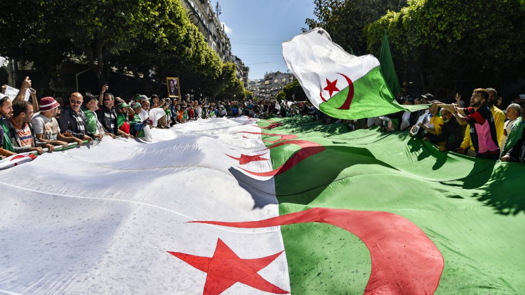 Ryad Kramdi, AFP | Algerian protesters march with a giant national flag during a demonstration in the capital Algiers on May 31, 2019.