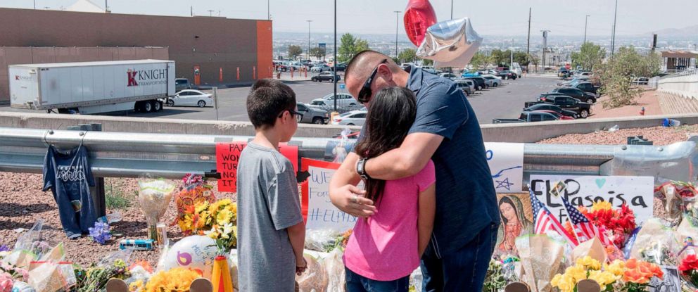 PHOTO: Members of the Soto family embrace beside a makeshift memorial after the shooting at the Cielo Vista Mall WalMart in El Paso, Texas, Aug. 5, 2019.Mark Ralston/AFP/Getty Images