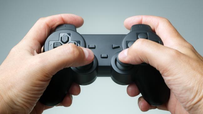 Video game console controller in gamer handsSource:istock