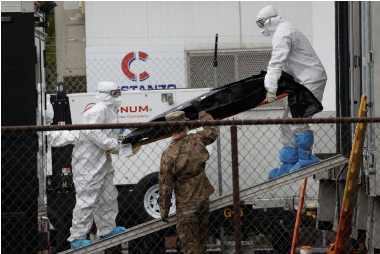 MIKE SEGAR / REUTERS Workers move a deceased coronavirus patient in New Jersey.