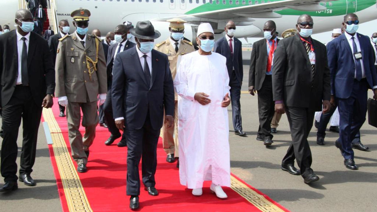 Mali's President Ibrahim Boubacar Keita walks with his Ivory Coast counterpart Alassane Ouattara upon his arrival in Bamako, Mali July 23, 2020. VIA REUTERS - HANDOUT