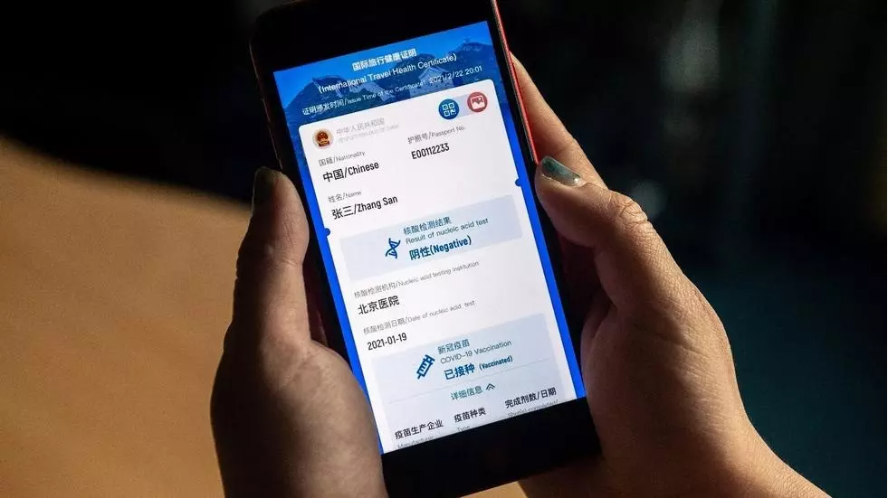 A phone displaying a mock-up of China’s new digital health certificate, a "virus passport" concept, which shows a user's vaccination status and virus test results, in an illustration photo taken in Beijing on March 9, 2021. © Nicolas Asfour