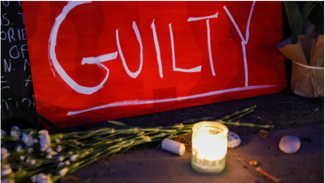 A sign rests next to a candle in New York after the verdict in the trial of former Minneapolis police officer Derek Chauvin, who was convicted of killing George Floyd on Tuesday. (Caitlin Ochs/Reuters)