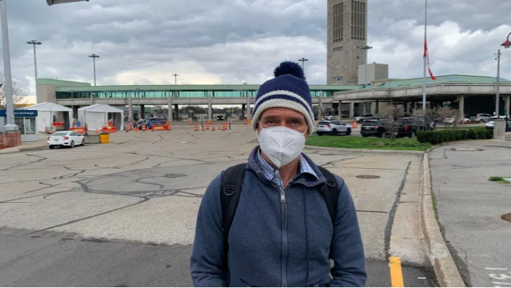 Greg Peacock of Toronto walked across the Rainbow Bridge in Niagara Falls, Ont., into Canada on the morning of April 15 after flying from Los Angeles to Buffalo, N.Y.  (Laura Clementson/CBC)