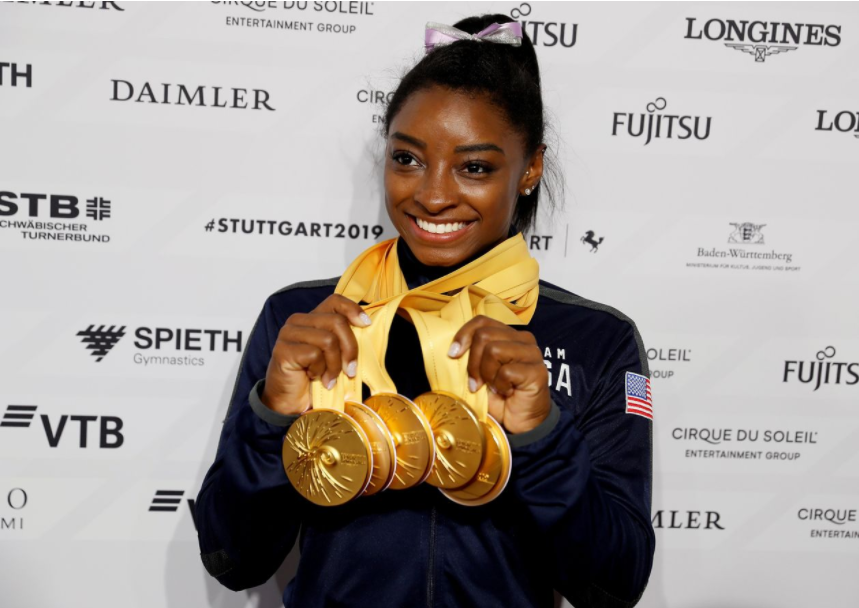 Simone Biles celebrates with her five gold medals at the 2019 world championships in Stuttgart, Germany. PHOTO: WOLFGANG RATTAY/REUTERS