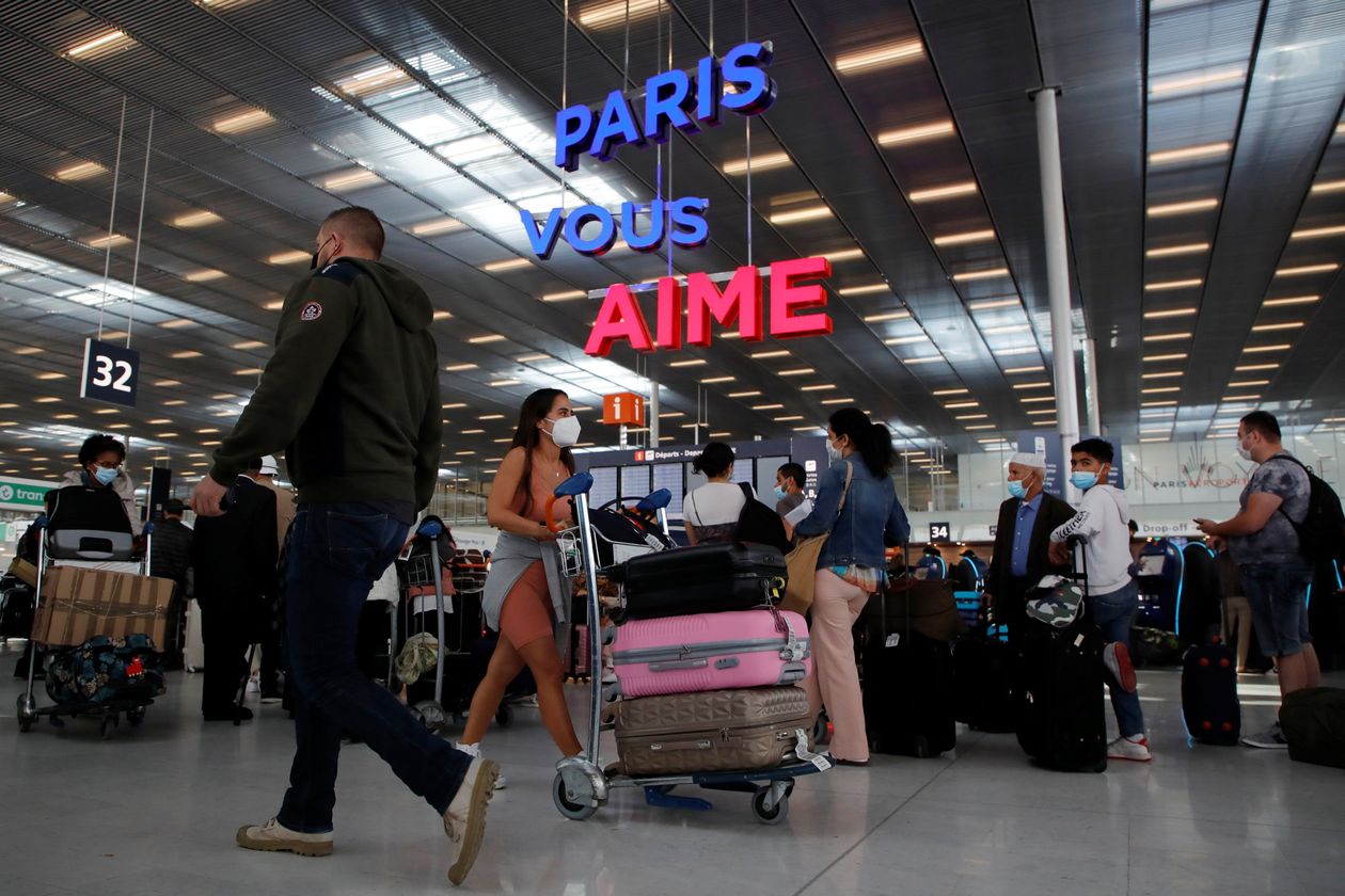 Passengers waited to check in at Orly Airport, near Paris, on Thursday. PHOTO: SARAH MEYSSONNIER/REUTERS