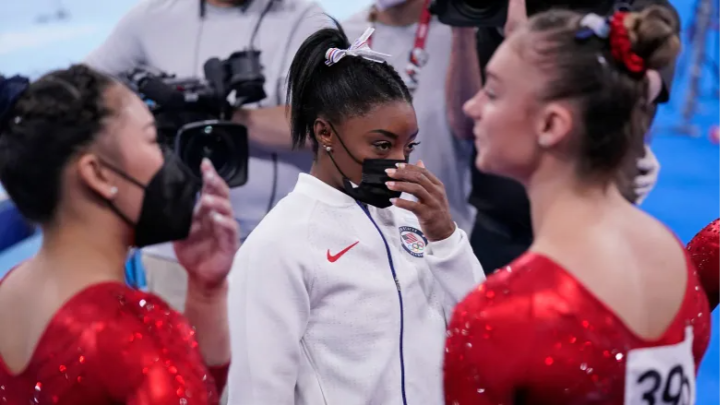 Simone Biles of the United States stands with teammates after exiting the team gymnastics final on Tuesday. (Gregory Bull/The Associated Press)