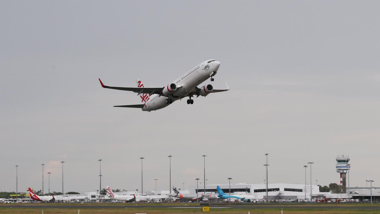 A Virgin Australia Boeing 737 commercial passenger jet plane flies out of the Cairns Airport. Picture: Brendan Radke