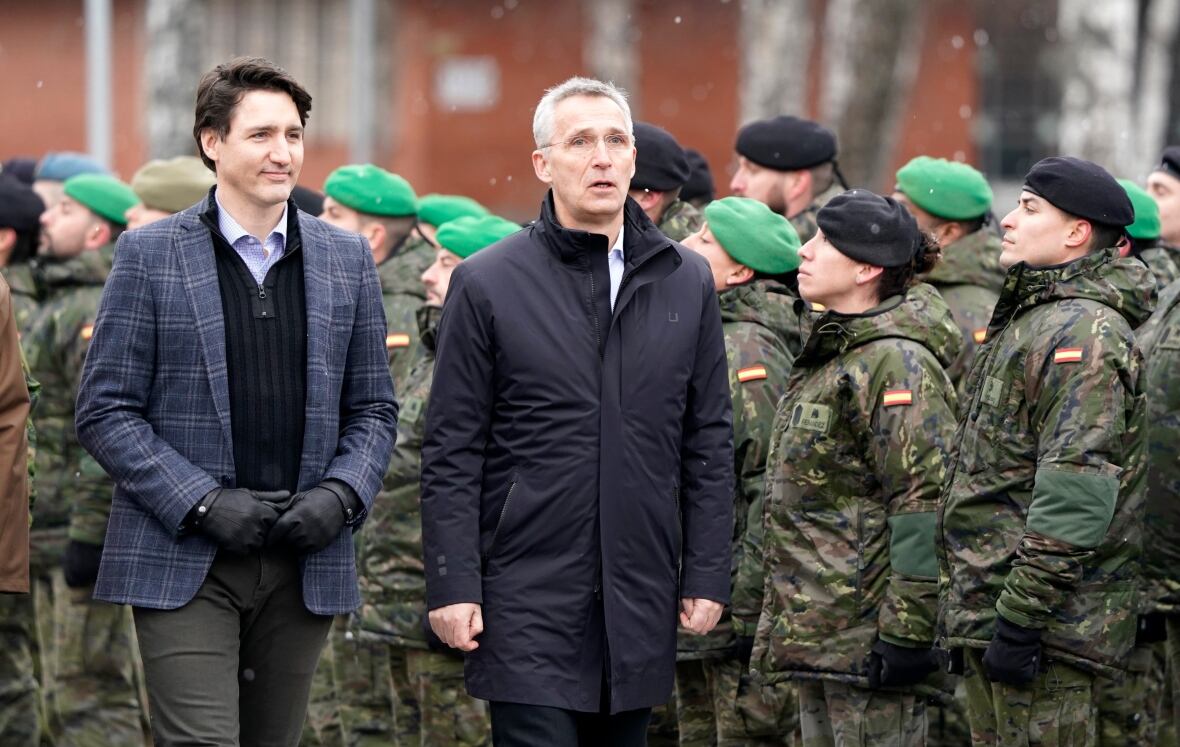 Prime Minister Justin Trudeau, left, and NATO Secretary General Jens Stoltenberg walk during their visit to Adazi Military base in Kadaga, Latvia, Tuesday, March. 8, 2022. (Roman Koksarov/AP)
