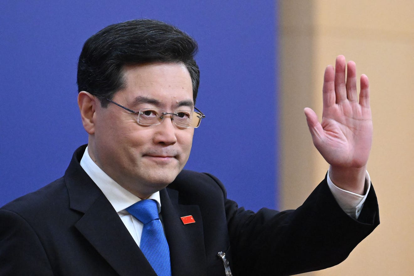 (FILES) China's former Foreign Minister Qin Gang waves as he arrives for a press conference at the Media Center of the National People's Congress in Beijing on March 7, 2023.