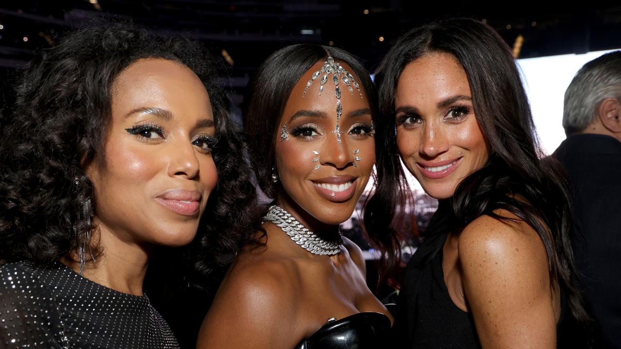 Meghan smiled and posed for pictures with Kerry Washington (left) and singer Kelly Rowland. Picture: Kevin Mazur/WireImage