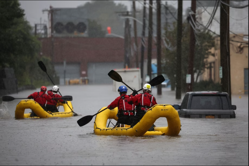 Special Operations Unit rescue personnel with the Westchester County Emergency Services paddle in rafts as they check buildings for victims trapped in heavy flooding in the New York City suburb of Mamaroneck on Sept. 29. Mike Segar/Reuters