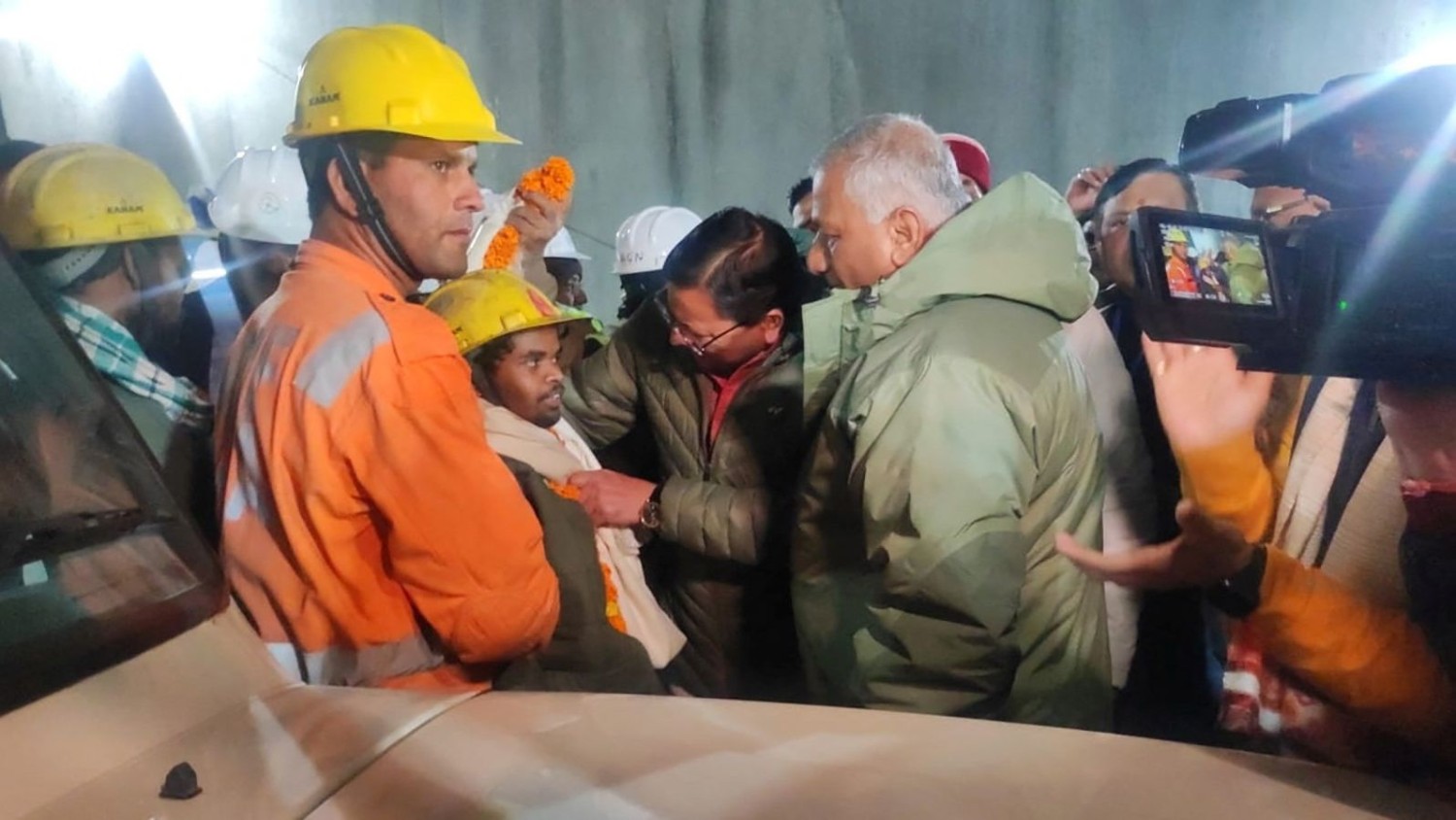 One of the rescued workers (center) pictured after leaving the tunnel. Uttarkashi District Information/Reuters