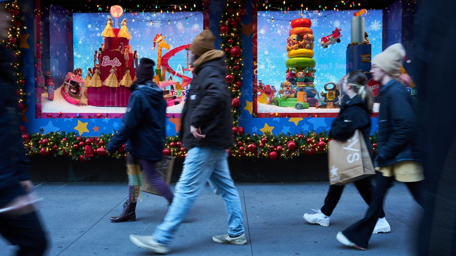Shoppers walk past holiday window displays at the Macy's Inc. flagship store in the Herald Square area of New York, US, on Monday, Nov. 13, 2023. Bing Guan/Bloomberg/Getty Images