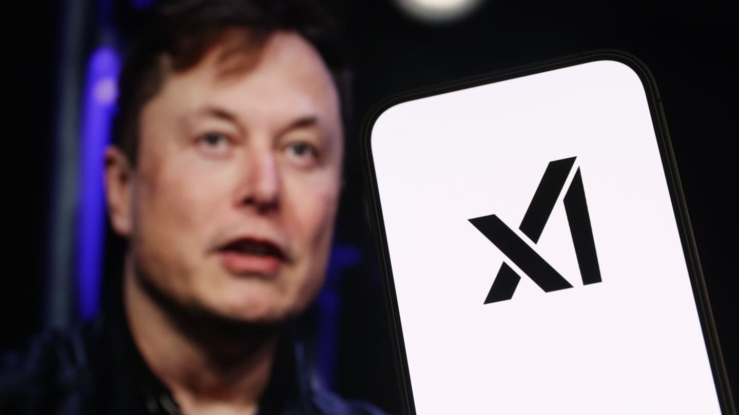 In this photo illustration, the logo of "xAI" is displayed on a mobile phone screen in front of Elon Musk's photo, July 13, 2023. (Hakan Nural/Anadolu Agency via Getty Images / Getty Images)