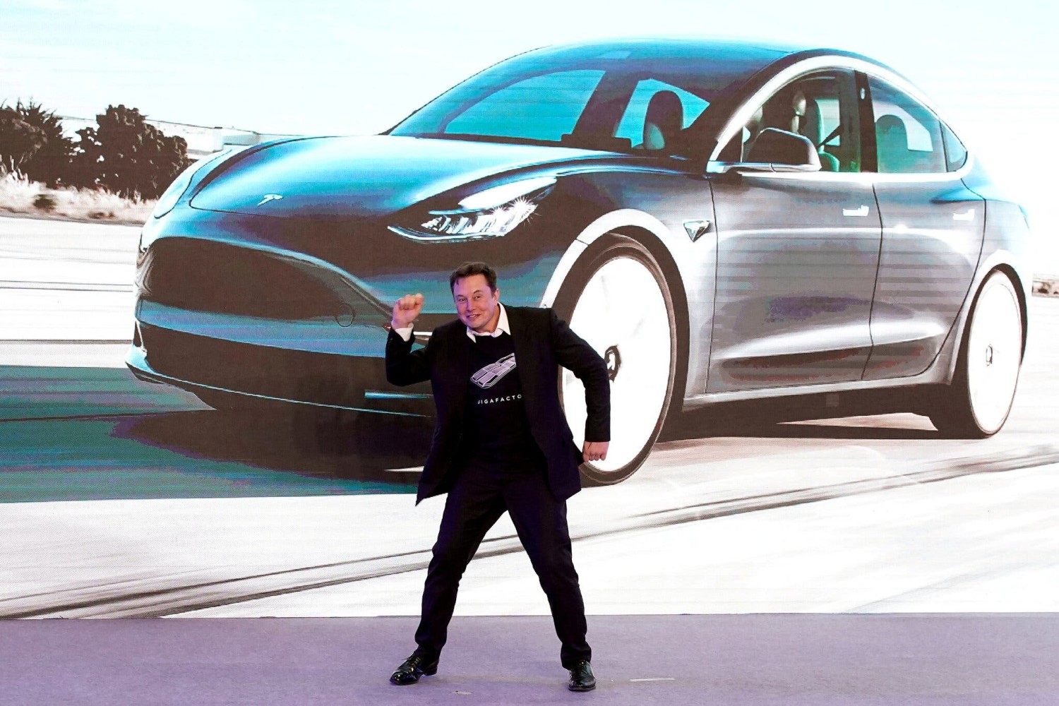 Elon Musk, Tesla’s chief executive, dancing onstage during a delivery event for Tesla’s China-made Model 3 cars in Shanghai in 2020.Credit...Aly Song/Reuters