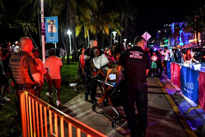 Miami Beach Fire Rescue transport a woman on a stretcher on Ocean Drive in Miami Beach, Florida on March 17, 2022. CHANDAN KHANNA, AFP Via Getty Images