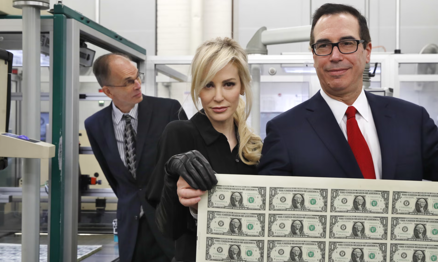 Steven Mnuchin, right, and his wife, Louise Linton, hold up a sheet of new $1 bills in Washington DC in November 2017. Photograph: Jacquelyn Martin/AP