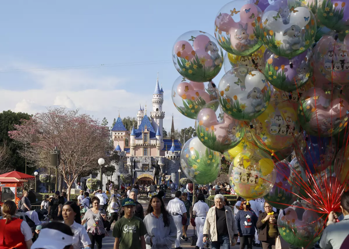 Visitors walk down Main Street, U.S.A. at Disneyland in Anaheim. (Allen J. Schaben / Los Angeles Times)