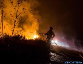 Firefighters work to extinguish the Thomas Fire as it burns past the 101 Highway towards the Pacific Coast Highway in Ventura, California, December 7, 2017.