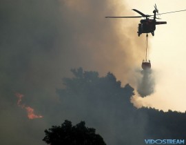 A helicopter drops water while battling the Thomas fire in Ojai, Calif., on Dec. 7, 2017.