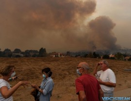 Local residents keep watch while fire and smoke from the Thomas wildfire heads towards their housing estate in Ojai, Calif. on Dec. 9, 2017. Brutal winds that fueled southern California's firestorm finally began to ease Saturday, giving resident