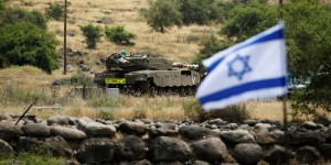 Image: An Israeli tank can be seen near the Israeli side of the border with