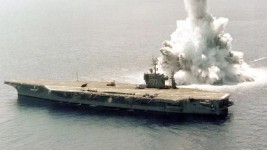 A United States aircraft carrier undergoes explosive 'shock' testing. A Chinese admiral says that sinking two US carriers would cow the US into withdrawing from the western Pacific.Source:Supplied