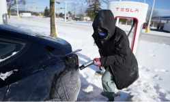 Ankita Bansal prepares to charge her Tesla in Ann Arbor, Michigan, on Wednesday. Photograph: Carlos Osorio/AP