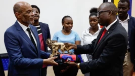 Haitian Prime Minister Ariel Henry receives a gift from the Principal Secretary, State department for foreign affairs Dr. Abraham Korir Sing'Oei at a university in Nairobi on March 1, 2024. © Simon Maina, AFP
