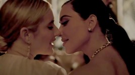 Kim Kardashian shares a kiss with Emma Roberts in the new season of AHS. Picture from YouTube.