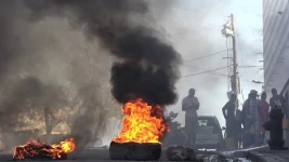 Getty Images / Tyres were set on fire outside the main prison in the Haitian capital, Port-au-Prince