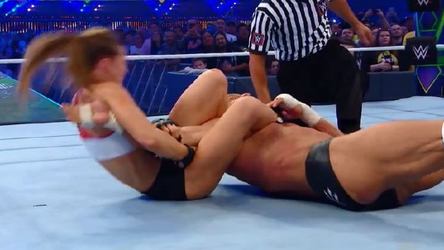 Ronda Rousey's locks in an armbar on Triple H.Source:Supplied