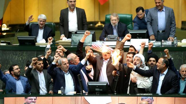 Iranian MPs burning a US flag in the parliament in Tehran. Picture: AFPSource:AFP
