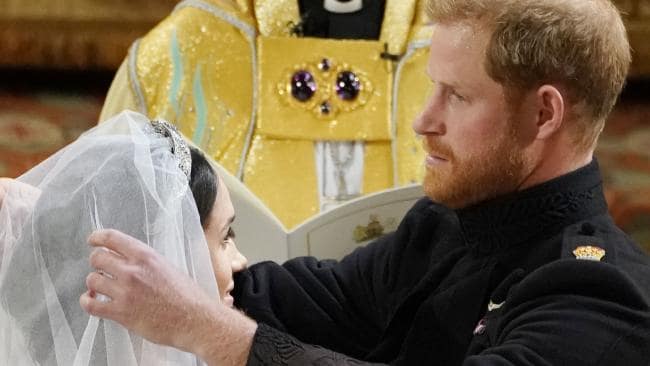 Prince Harry lifts the veil of his bride, Meghan Markle. Credit: AFP Photo/Pool/Owen HumphreysSource:AFP