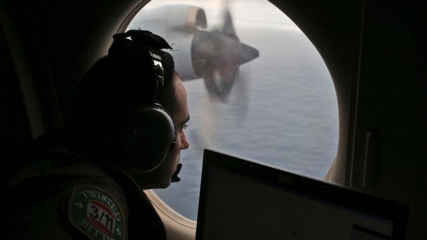 In this March 22, 2014, file photo, flight officer Rayan Gharazeddine scans the water in the southern Indian Ocean off Australia from a Royal Australian Air Force AP-3C Orion during a search for the missing Malaysia Airlines Flight MH370.  (AP Photo&#