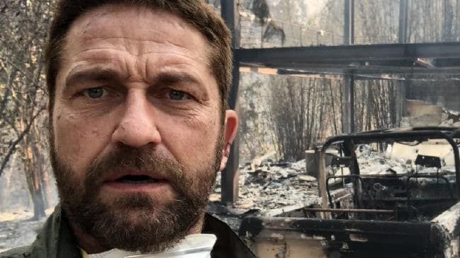 Gerard Butler stands in front of what remains of his house.Source:Twitter