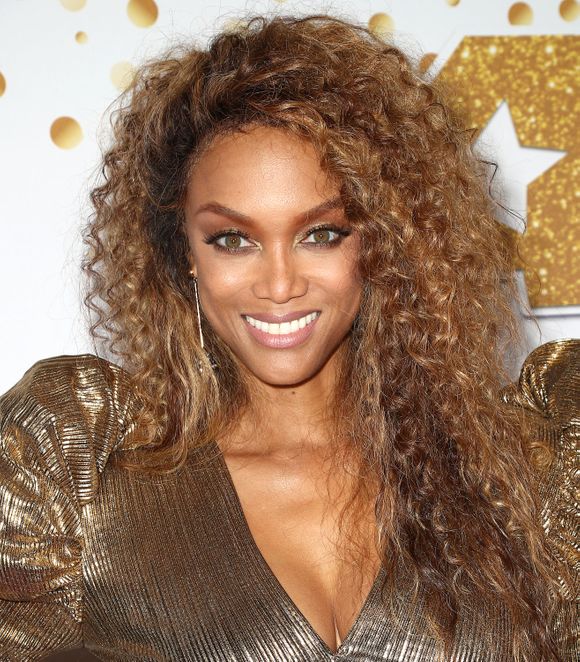 Tyra Banks sizzles on the cover of the Sports Illustrated Swimsuit issue in a bikini at 45